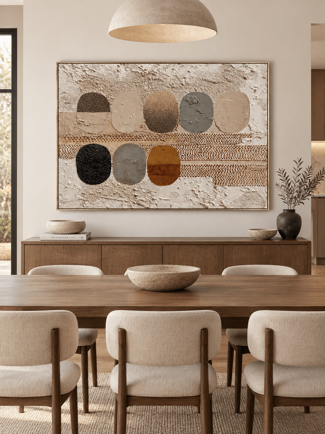 Hand-painted geometric wall art with organic oval shapes displayed in a modern open-plan dining room