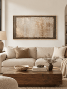Large neutral textured abstract wall art displayed above a cream sofa in a modern organic living room