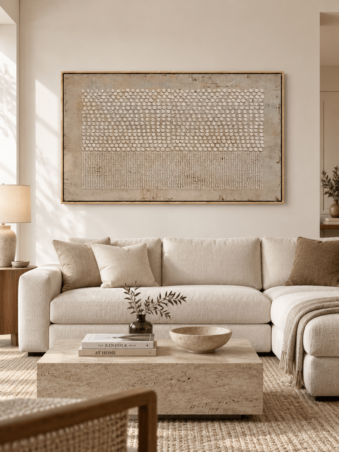 Large neutral textured abstract wall art with raised ivory dots displayed above a sofa in a modern organic living room