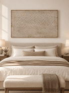 Minimalist dot and line abstract painting displayed above a bed in a warm neutral contemporary bedroom