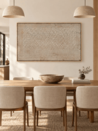 Hand-painted geometric textured wall art with ivory dots and vertical lines displayed in an open-plan dining room