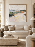 Large impressionist pastel landscape painting displayed above a cream sofa in a contemporary living room
