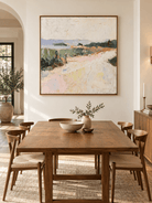Hand-painted textured countryside landscape in pastel colors displayed in a modern open-plan dining room