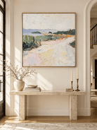 Square pastel landscape wall art with lavender blue hills and green fields displayed above an entryway console