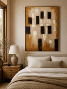 Brown and beige textured abstract painting displayed in a warm neutral bedroom with natural wood furniture