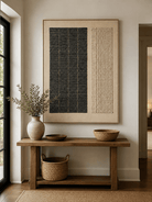 Vertical black and cream geometric wall art displayed above an entryway console in a minimalist Japandi interior