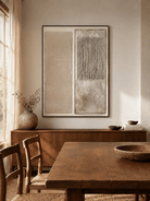 Minimalist neutral relief wall art displayed in an organic modern open dining room with natural wood furniture