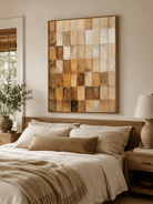 Warm earth tone abstract painting displayed in a neutral bedroom with cream bedding and natural wood furniture