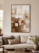 Large beige and brown textured wall art displayed above a cream sofa in an organic modern living room