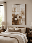 Warm neutral textured abstract painting in beige and brown displayed above the bed in a modern bedroom