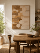 Large earth tone textured abstract wall art displayed in an organic modern open dining room with natural wood furniture