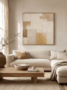 Large neutral textured geometric wall art displayed above a beige sofa in an organic modern living room
