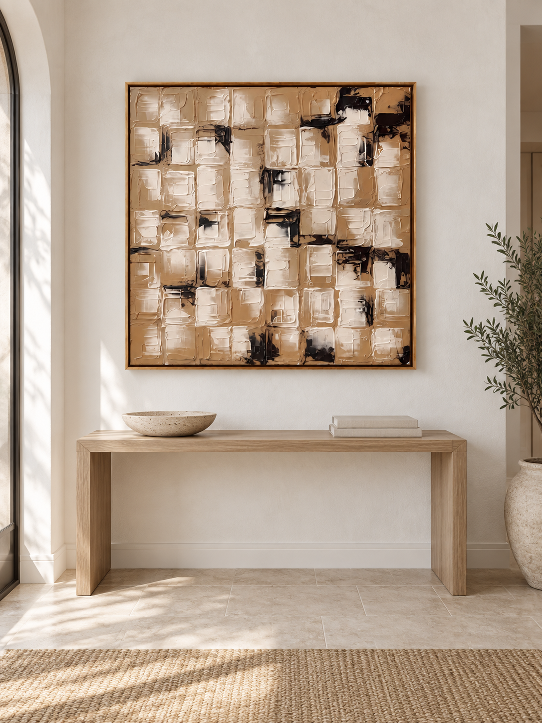Square beige and black wabi-sabi wall art displayed above an entryway console in a warm neutral interior