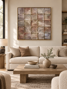 Large taupe textured geometric wall art displayed above a cream sofa in an organic modern living room