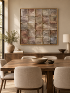 Large mineral-tone geometric wall art displayed in an organic modern open dining room with walnut furniture