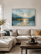 Blue and gold landscape wall art displayed above a modern living-room sofa