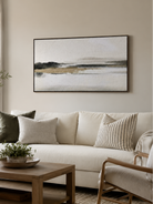 Black and white abstract landscape wall art above a neutral sofa