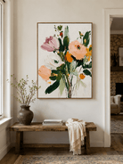 Vertical impasto floral wall art displayed above a console table in a welcoming modern entryway