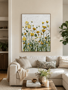 Yellow wildflower wall art displayed above a neutral sofa in an organic modern living room