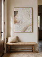 Vertical ivory textured wall art displayed above a console table in a contemporary entryway