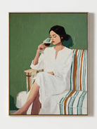 Hand painted modern figurative wall art of a woman in white holding a wine glass against a deep sage green background by Eleanor Hayes