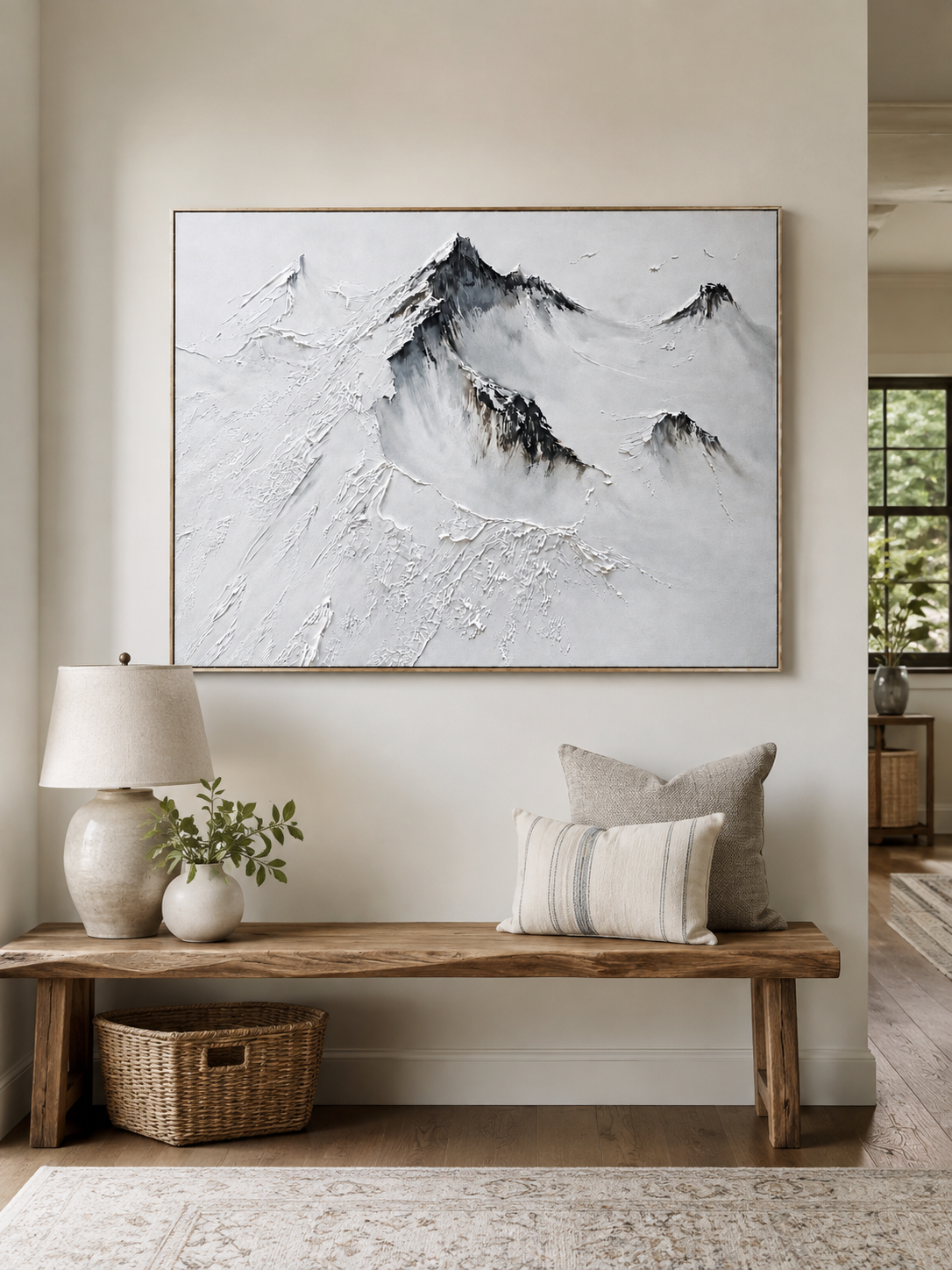 Black and white textured mountain wall art above a console in a modern neutral entryway