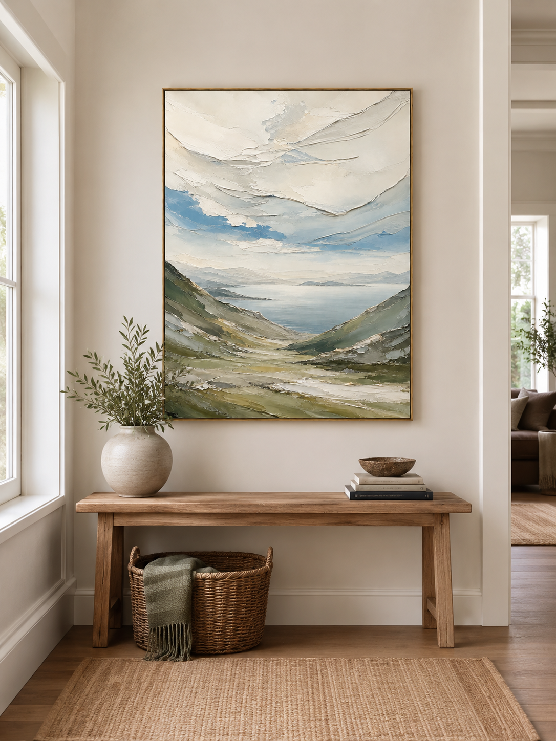 Textured mountain landscape wall art above an entryway console in an organic modern foyer