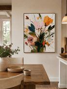 Modern textured floral painting displayed in a warm open-plan dining room
