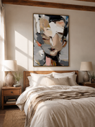 Textured impasto portrait wall art displayed above a bed in a warm minimalist bedroom