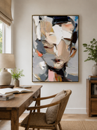 Textured face wall art above an entryway console in an organic modern foyer