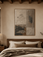 Beige and charcoal architectural abstract wall art displayed above a bed in a neutral bedroom