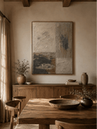 Textured geometric abstract painting displayed in a warm open-plan dining room