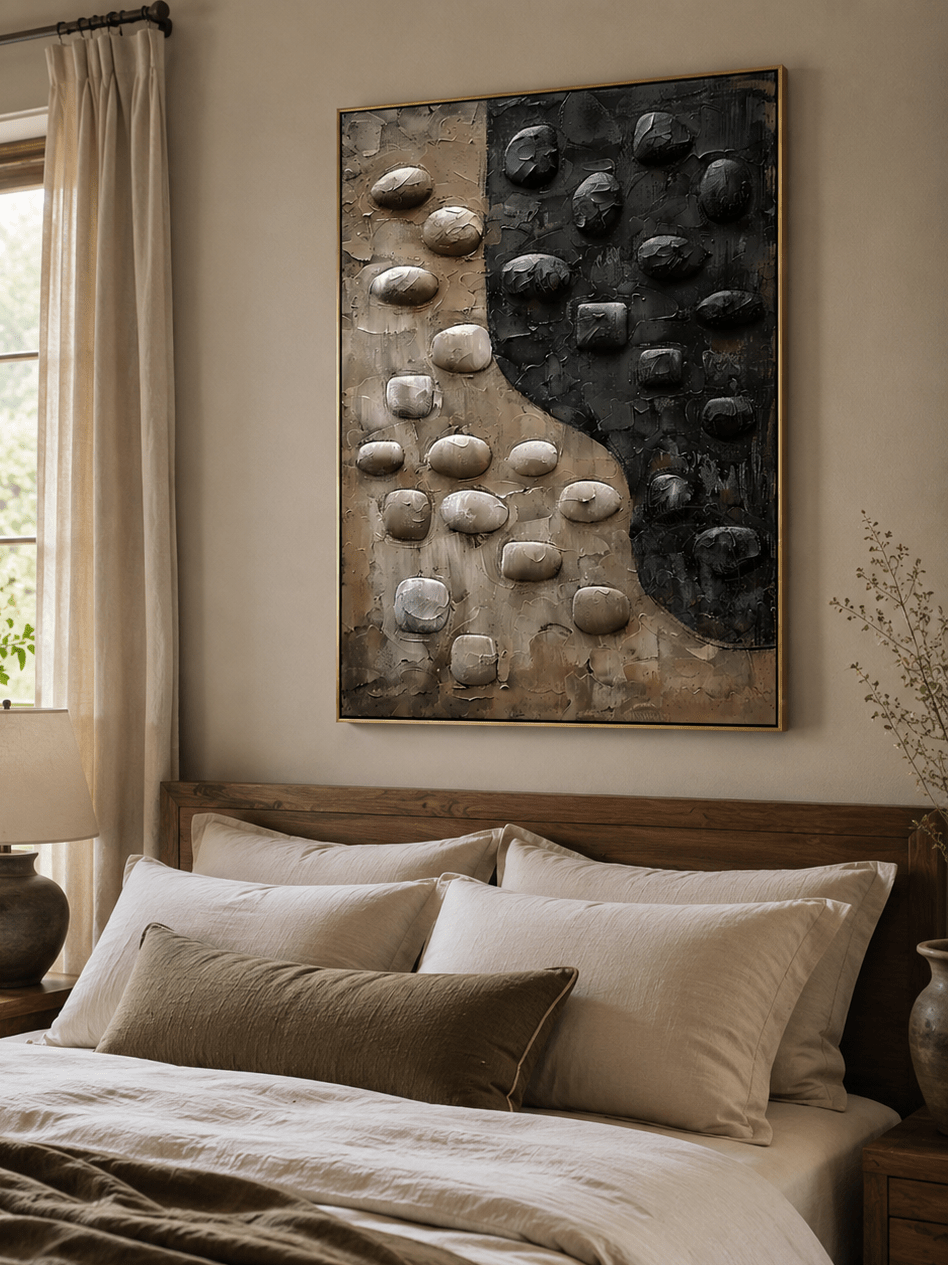 3D pebble wall art displayed above a bed in a warm neutral contemporary bedroom