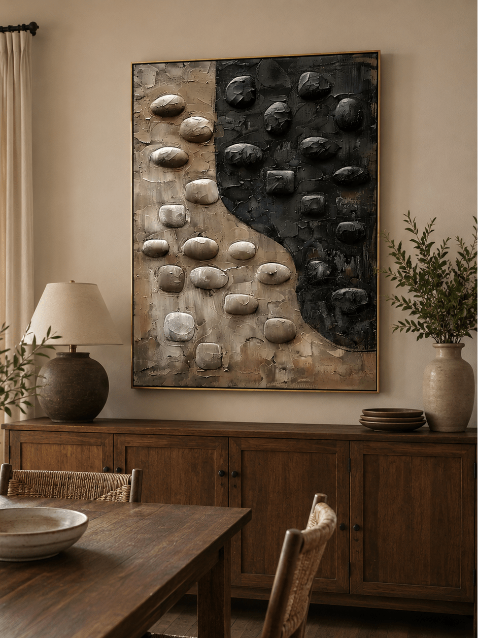 Sculptural black and beige wall art displayed in an organic modern open-plan dining room