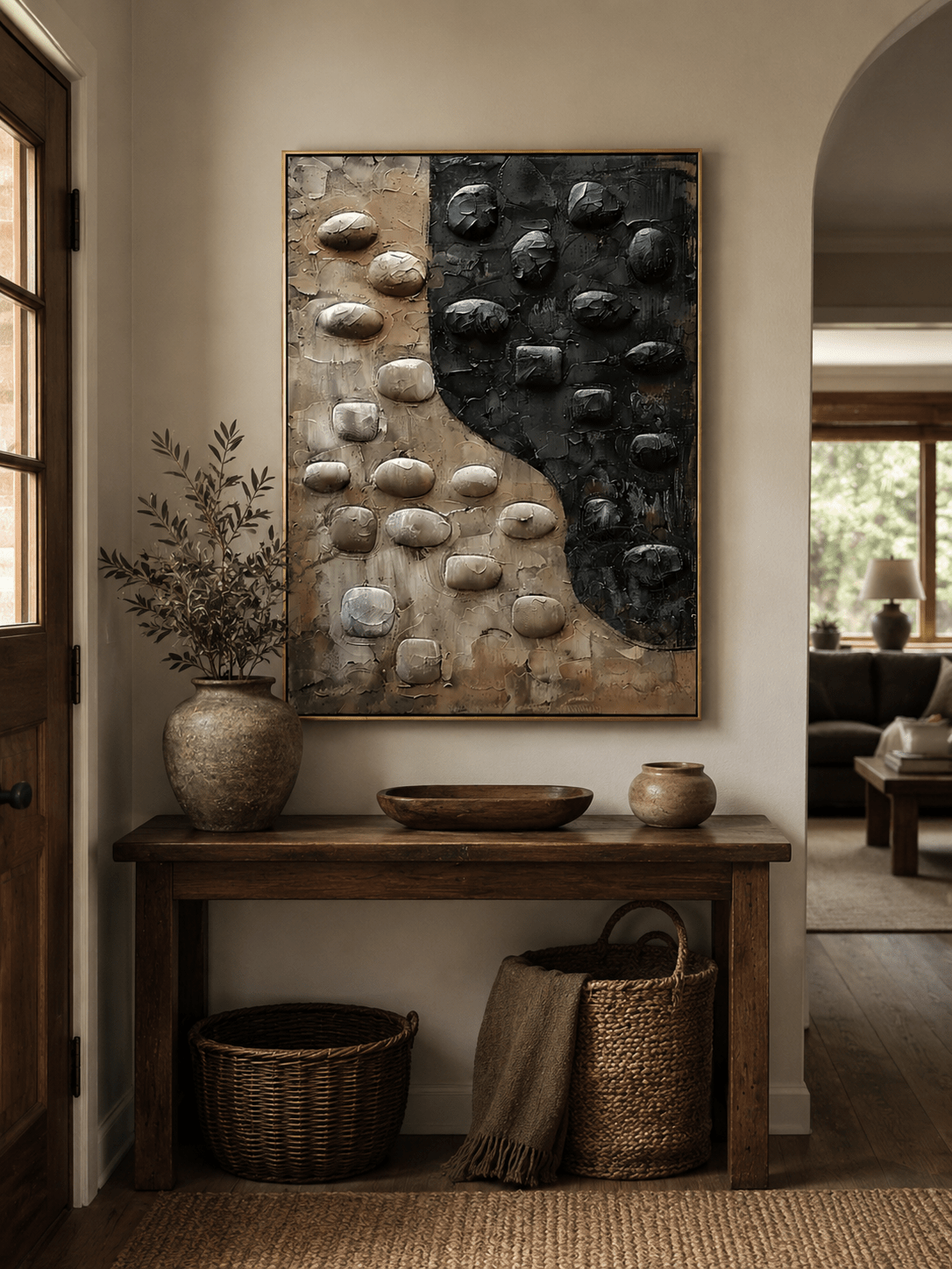 Wabi-sabi textured pebble wall art above an entryway console in a minimalist Japandi foyer