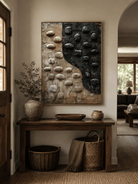 Wabi-sabi textured pebble wall art above an entryway console in a minimalist Japandi foyer