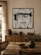 Abstract line portrait painting displayed in a contemporary open-plan dining room