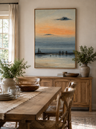 Hand-painted textured harbor sunset wall art displayed in a modern open-plan dining room with natural decor
