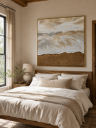 Beige and white textured coastal wall art displayed above the bed in a calm neutral modern bedroom