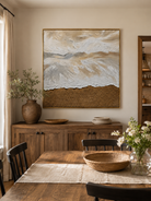 Hand-painted textured beach wave wall art displayed in a modern open-plan dining room with natural wood decor