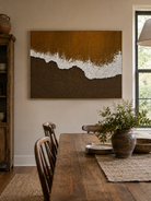Hand-painted textured ocean wave wall art displayed in a dining room with walnut and neutral decor