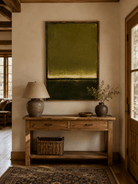 Vertical olive green color field painting displayed above a console in a modern entryway