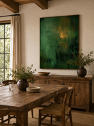 Hand-painted green abstract wall art displayed in a dining room with walnut furniture and neutral decor
