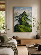 Green impasto mountain painting displayed above neutral furniture in an organic modern living room
