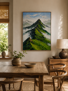 Hand-painted mountain landscape wall art displayed in a dining room with natural wood furniture