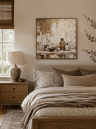 Beige textured still life wall art displayed above the bed in a warm neutral bedroom