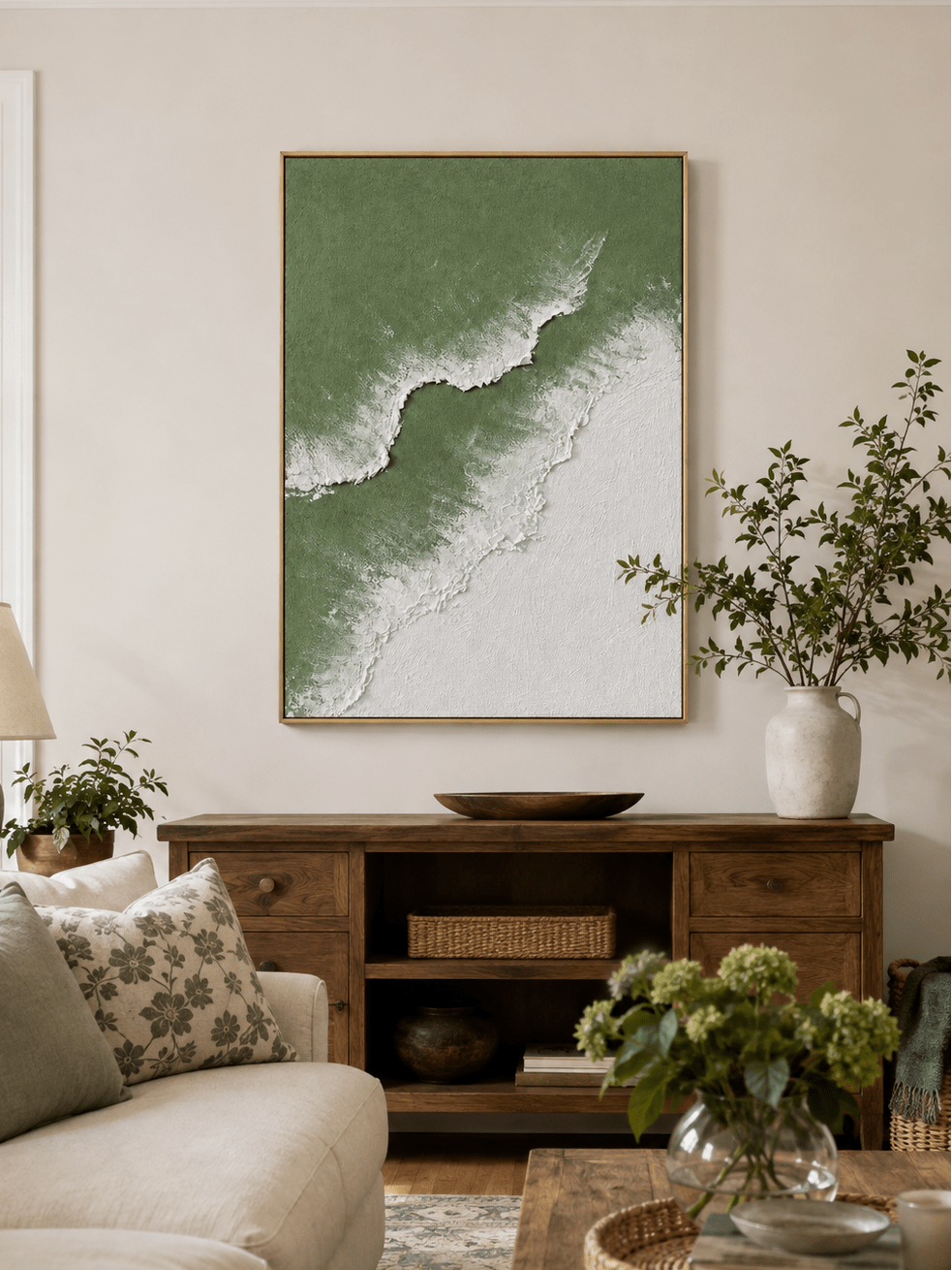 Sage green textured ocean wave painting displayed above neutral furniture in an organic modern living room