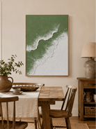 Hand-painted sage green ocean wall art displayed in a modern dining room with natural wood furniture