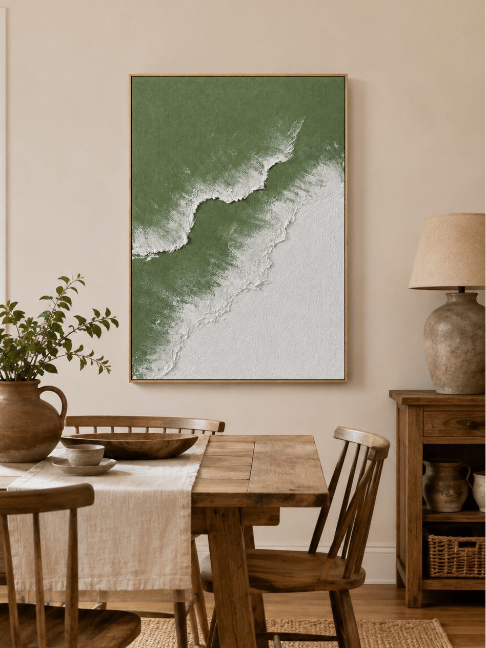 Hand-painted sage green ocean wall art displayed in a modern dining room with natural wood furniture