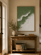 Vertical sage green wave painting displayed above a wood console in a minimalist modern entryway